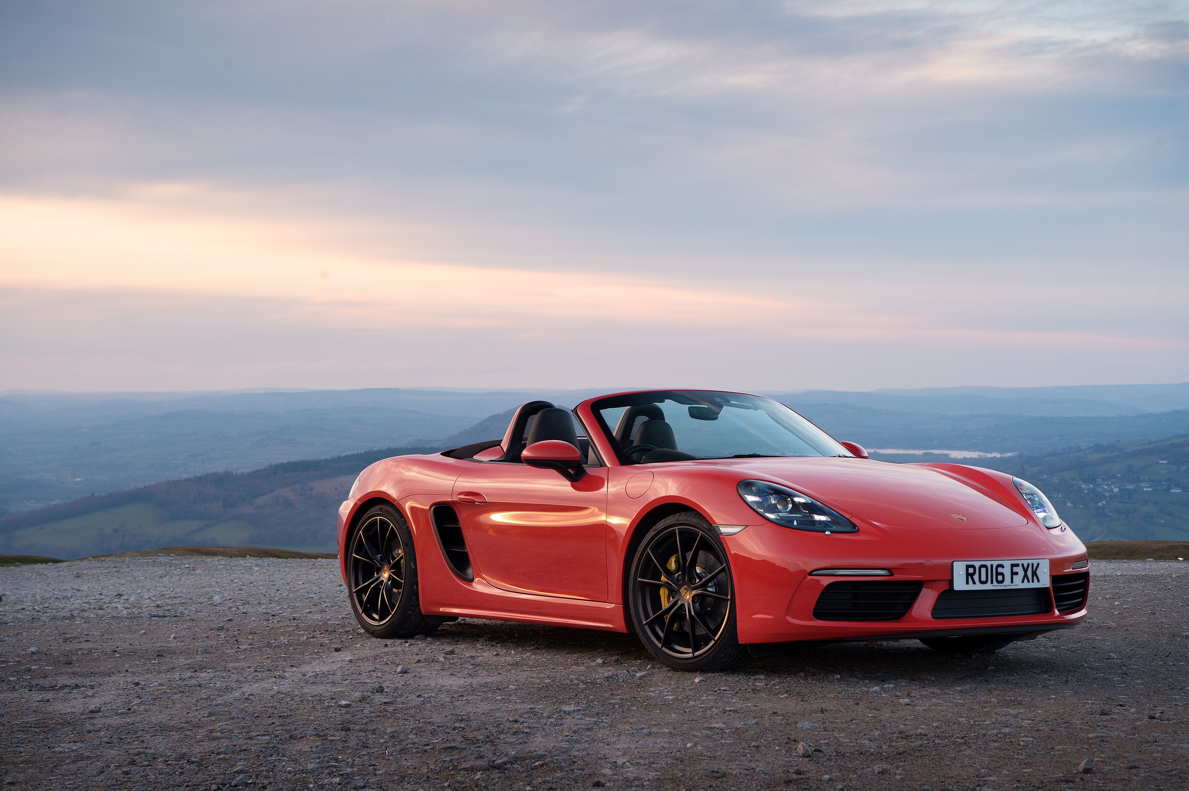 Red Car Convertible Porsche 718 Boxster on the background