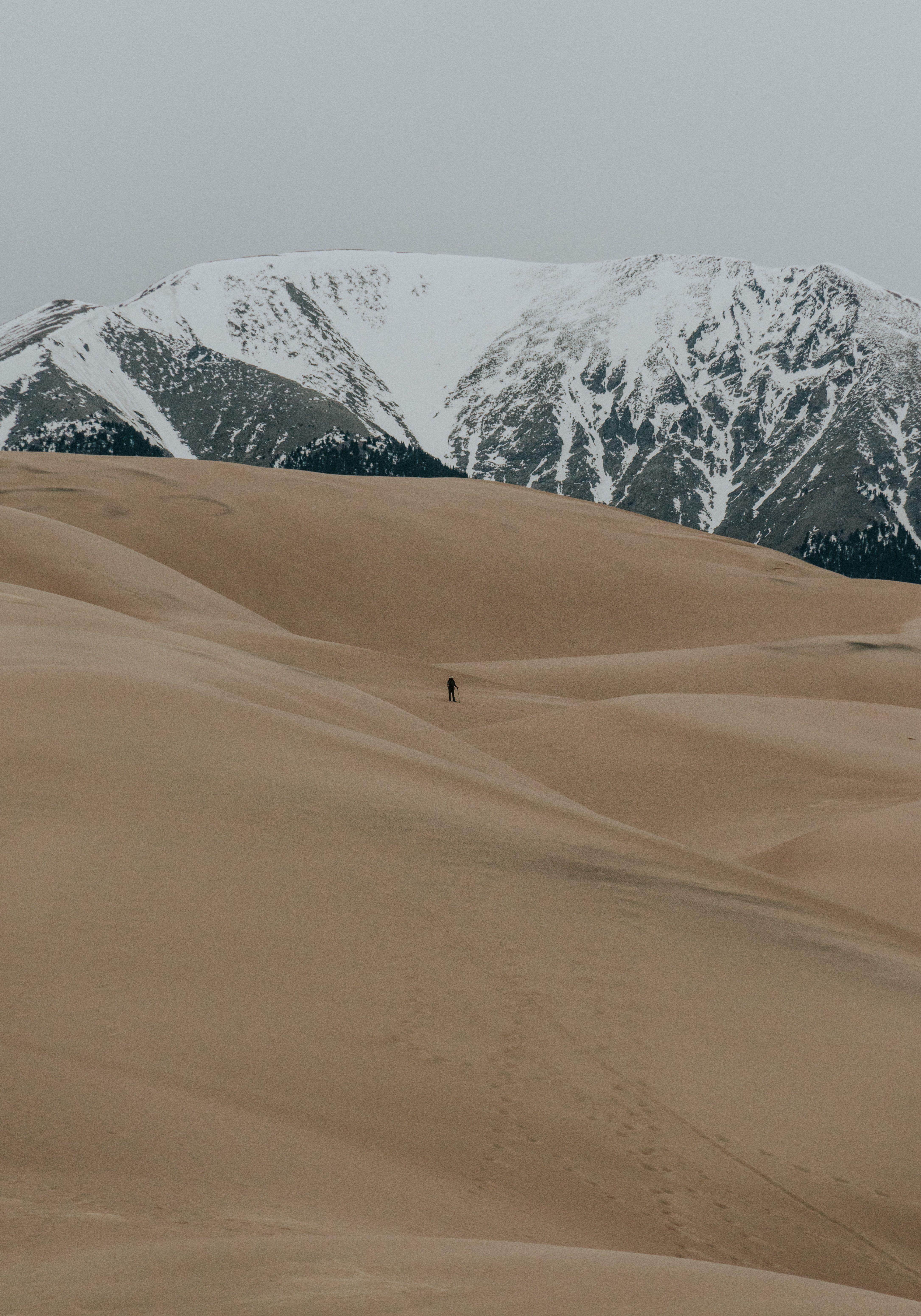 HD Wallpaper The silhouette of a lone hiker among sand dunes