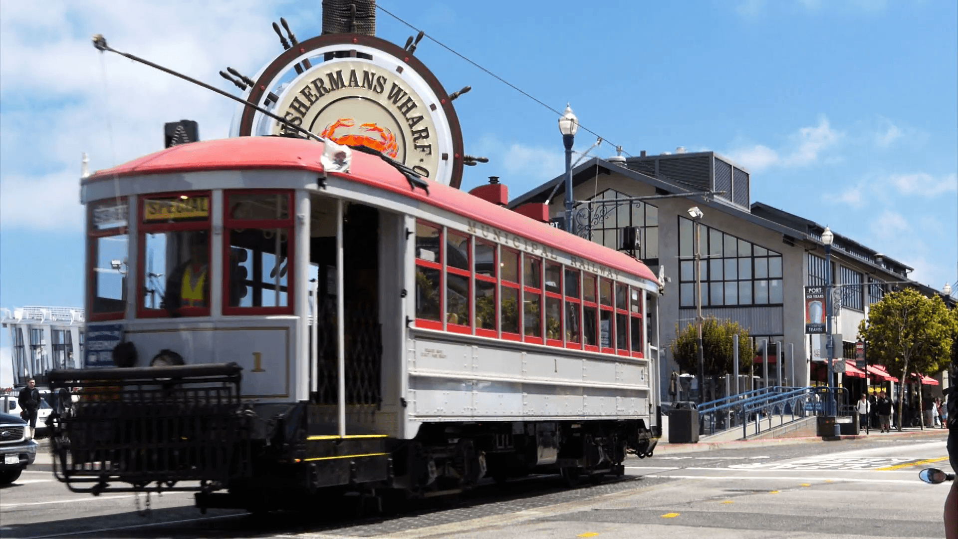 a cable car travels past the famous fisherman's wharf district