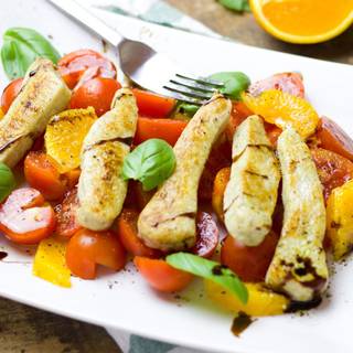 Chicken fillet with orange and cherry tomatoes