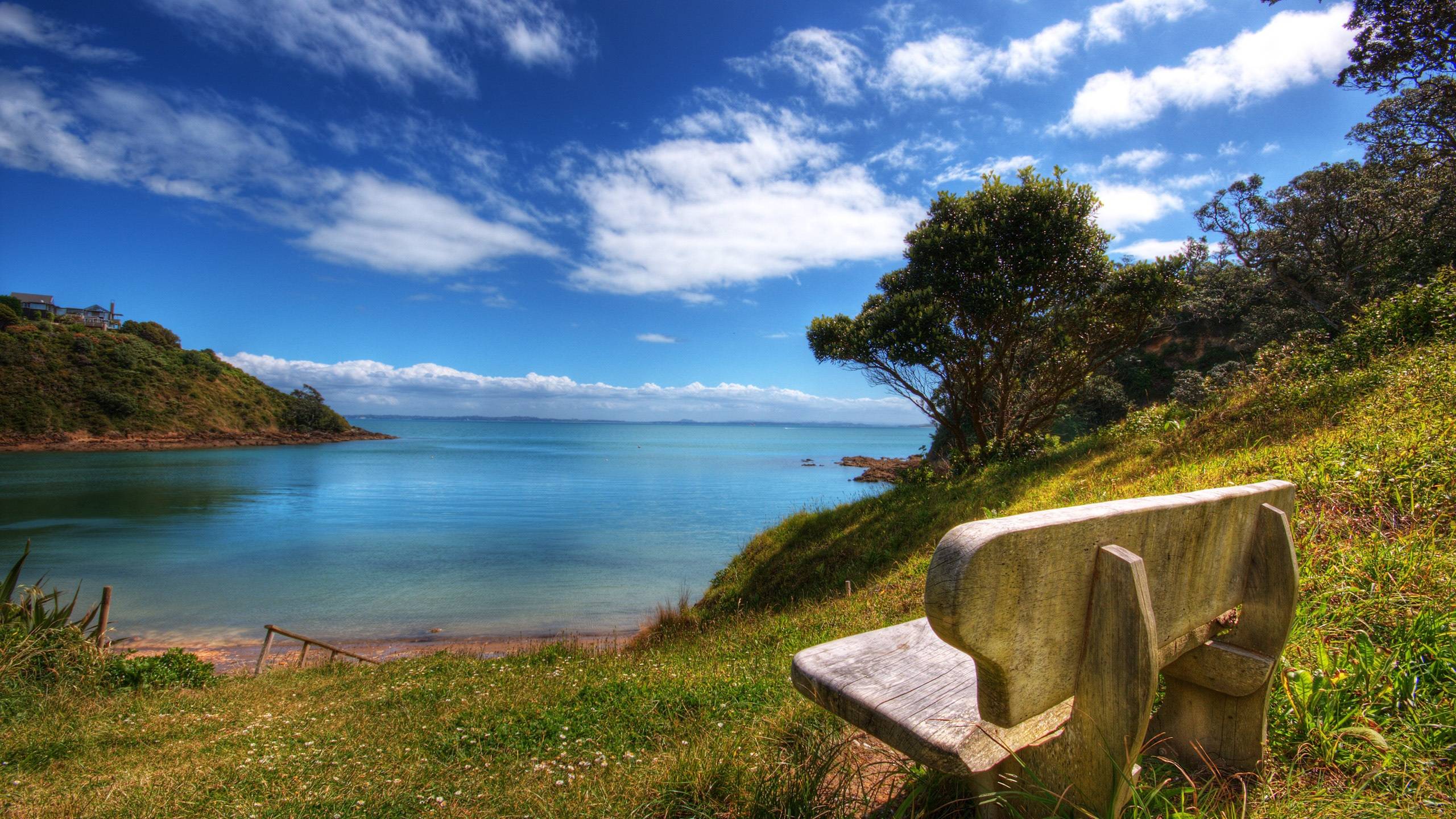 Wooden chairs and blue green water Wallpaperx1440