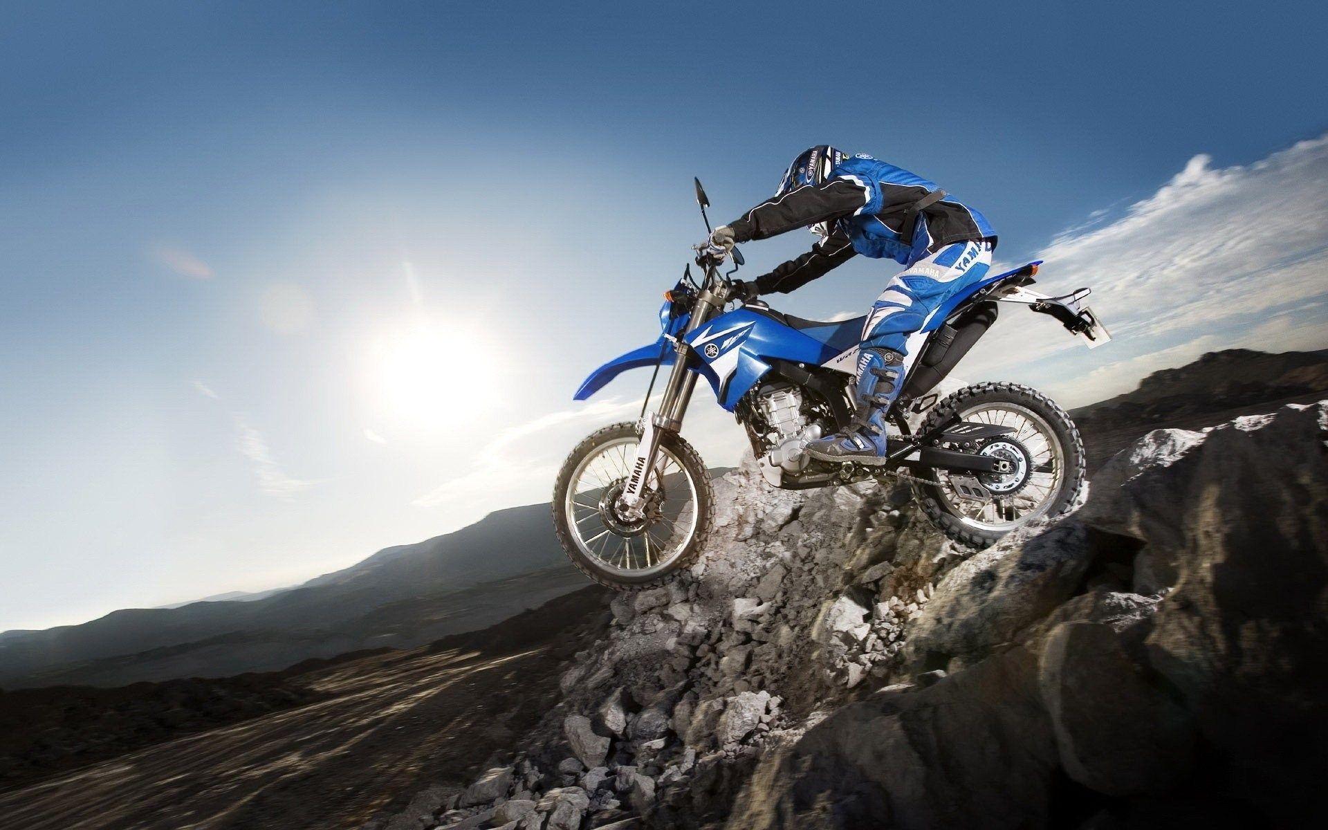 motocross rider jumping off cliff wide HD wallpaper
