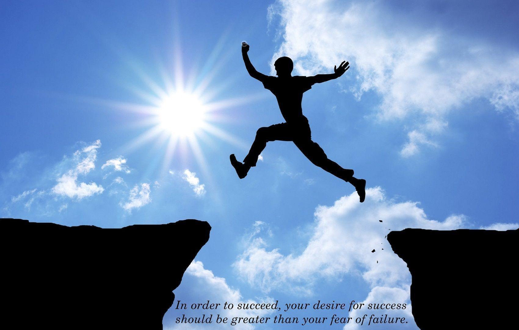  A black figure jumps over a cliff with the sun shining brightly in the background and the text "In order to succeed, your desire for success should be greater than your fear of failure."