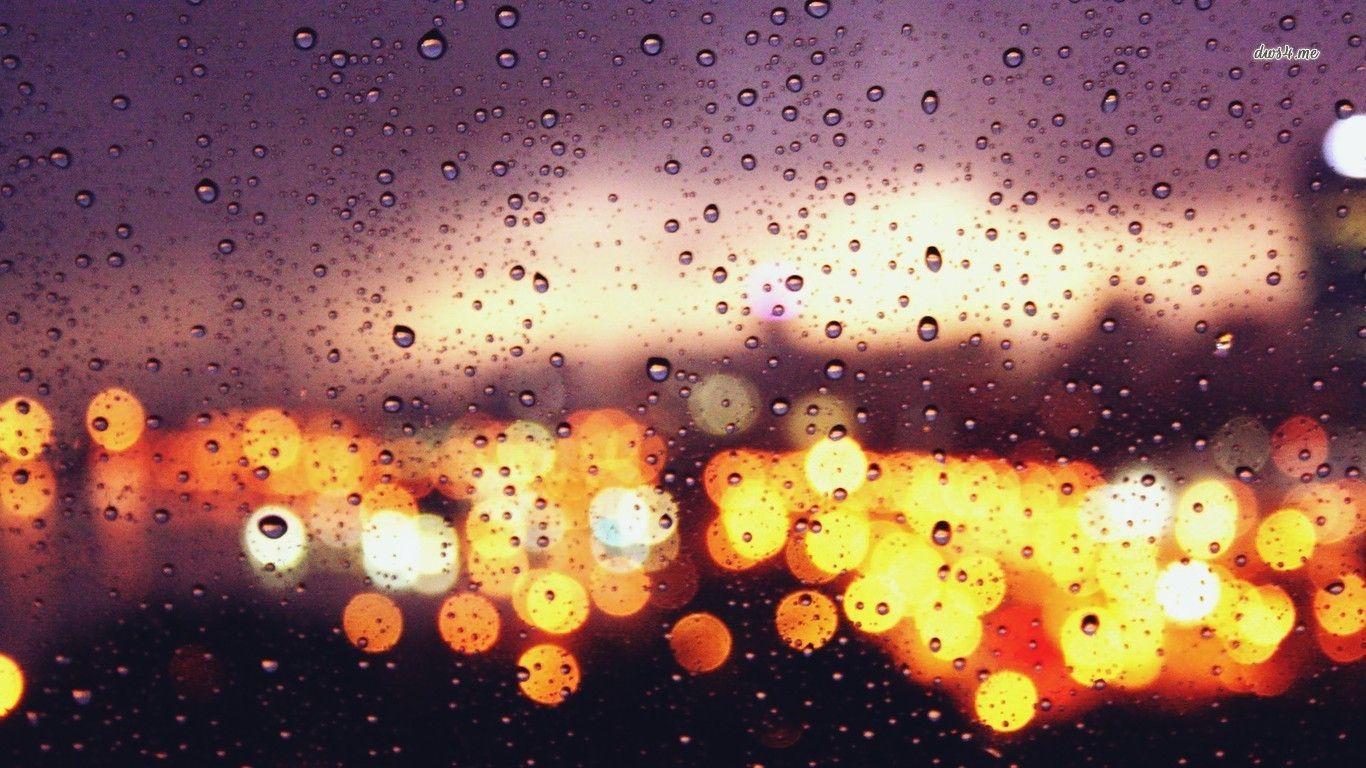 City lights behind the rainy window wallpaper