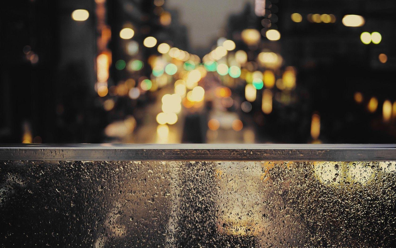 City lights beyond the rainy window wallpaper #