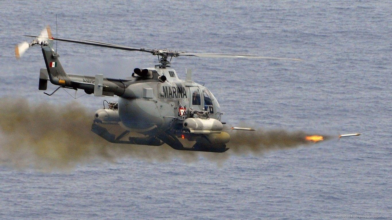 Download 1366x768 Military Helicopter Firing Some Rockets Wallpaper