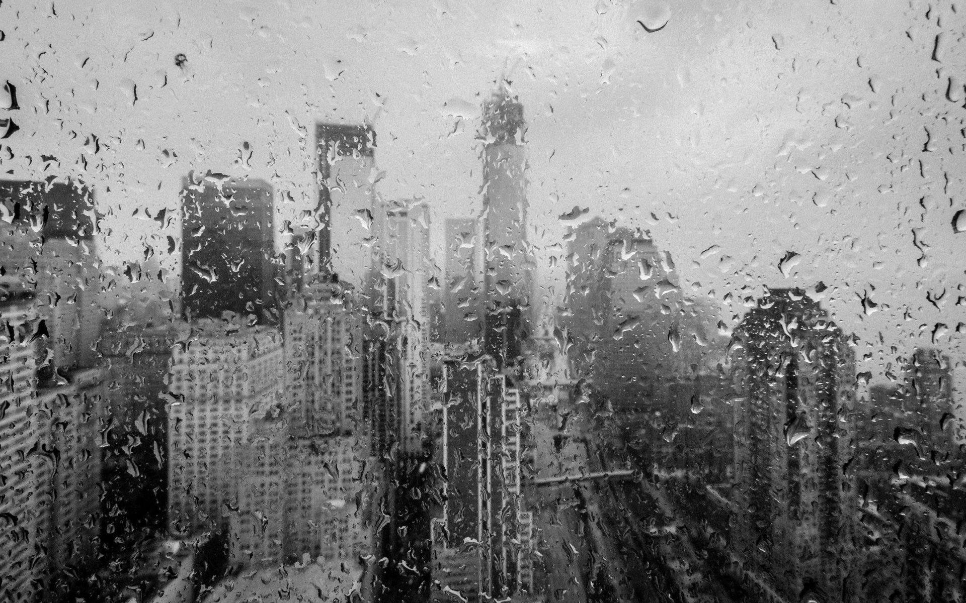 City view through wet window wallpaper