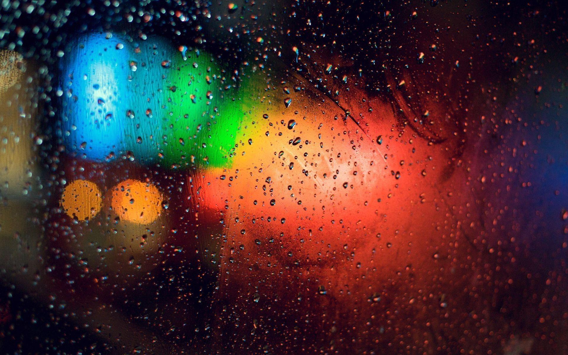 Colorful lights behind rainy window Wallpaper #