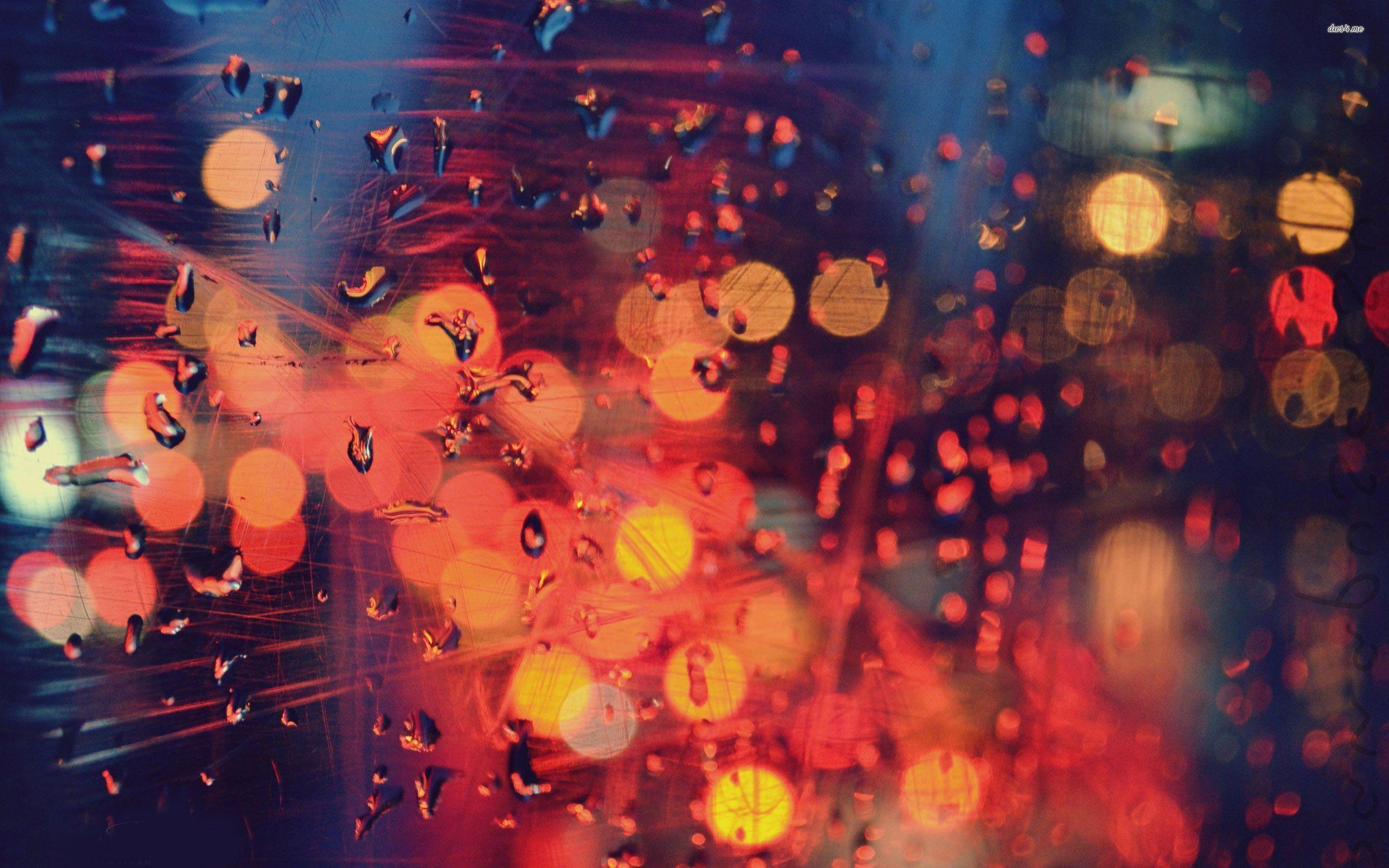 City lights beyond the rainy window wallpaper