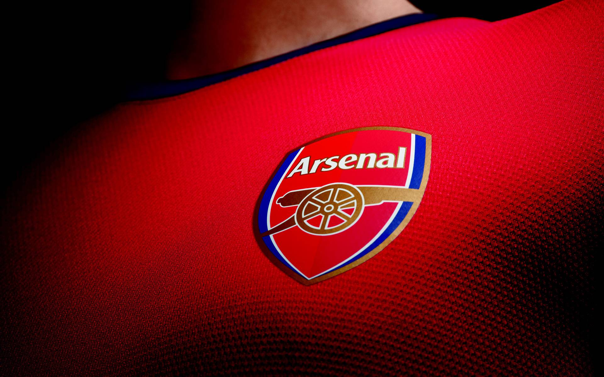 Arsenal Logo in Jersey Background Wallpaper