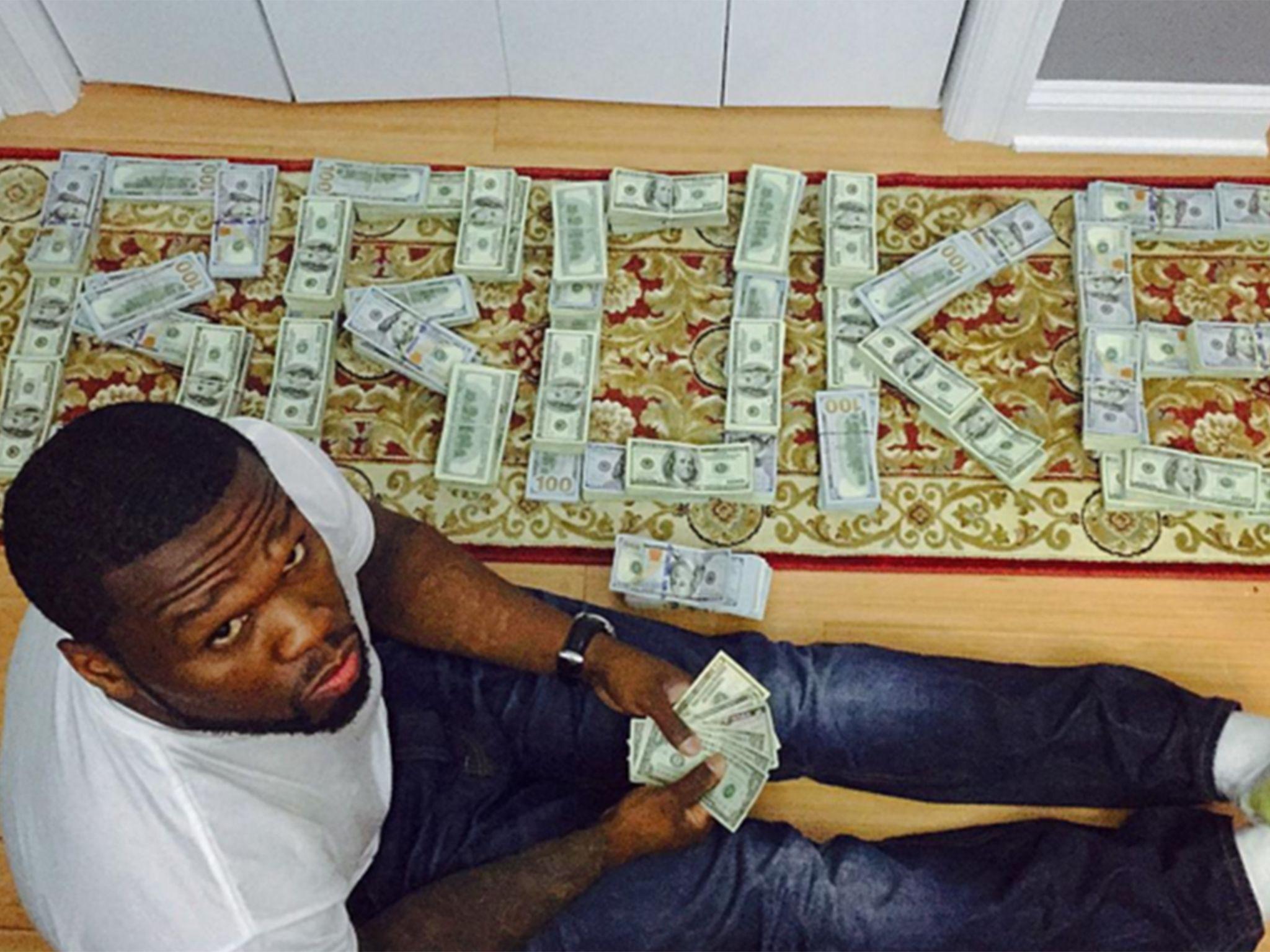 Broke&; 50 Cent ordered to court after posing with cash