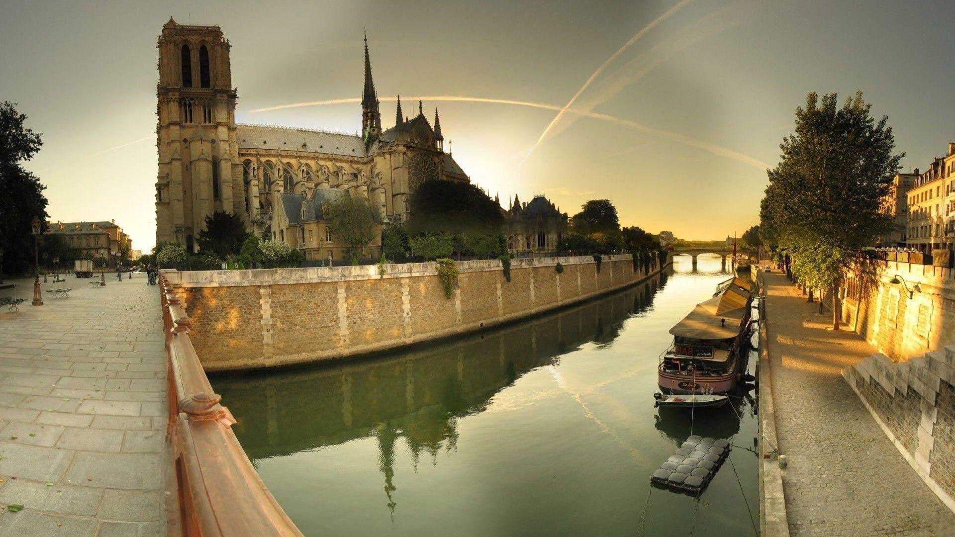 Notre dame cathedral by the seine river wallpaper. AllWallpaper