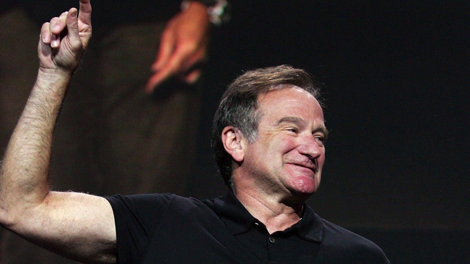 The famous Robin Williams shows his hand up wallpaper and image