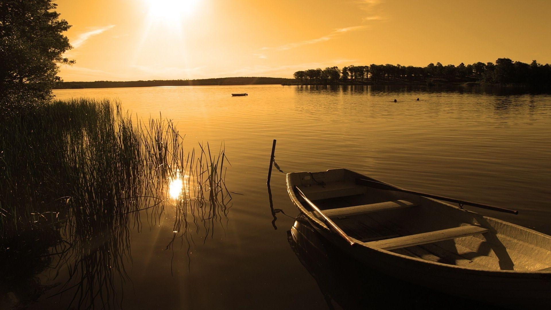 Rowing boat on the lake among the reeds. Android wallpaper for free