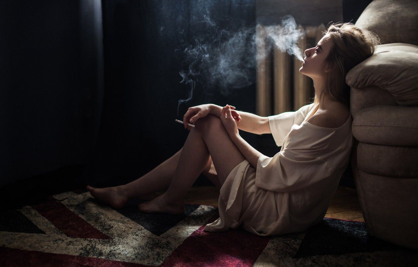 Курящая девушка на диване