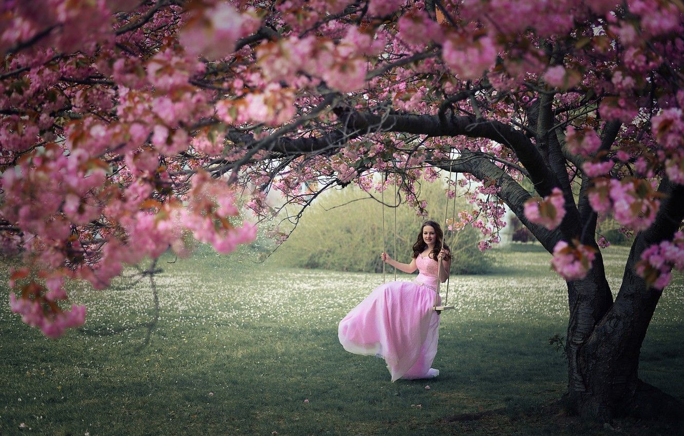 Swinging in flower garden