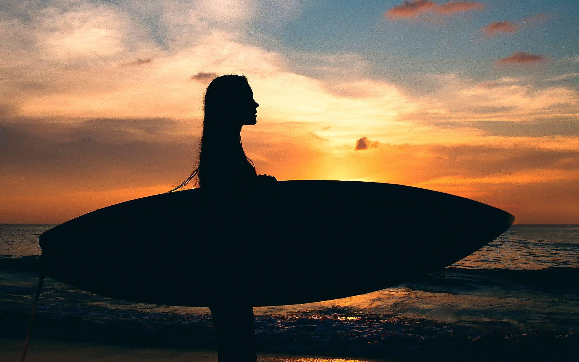 Girl Surfing in Sea Sunset Wallpaper