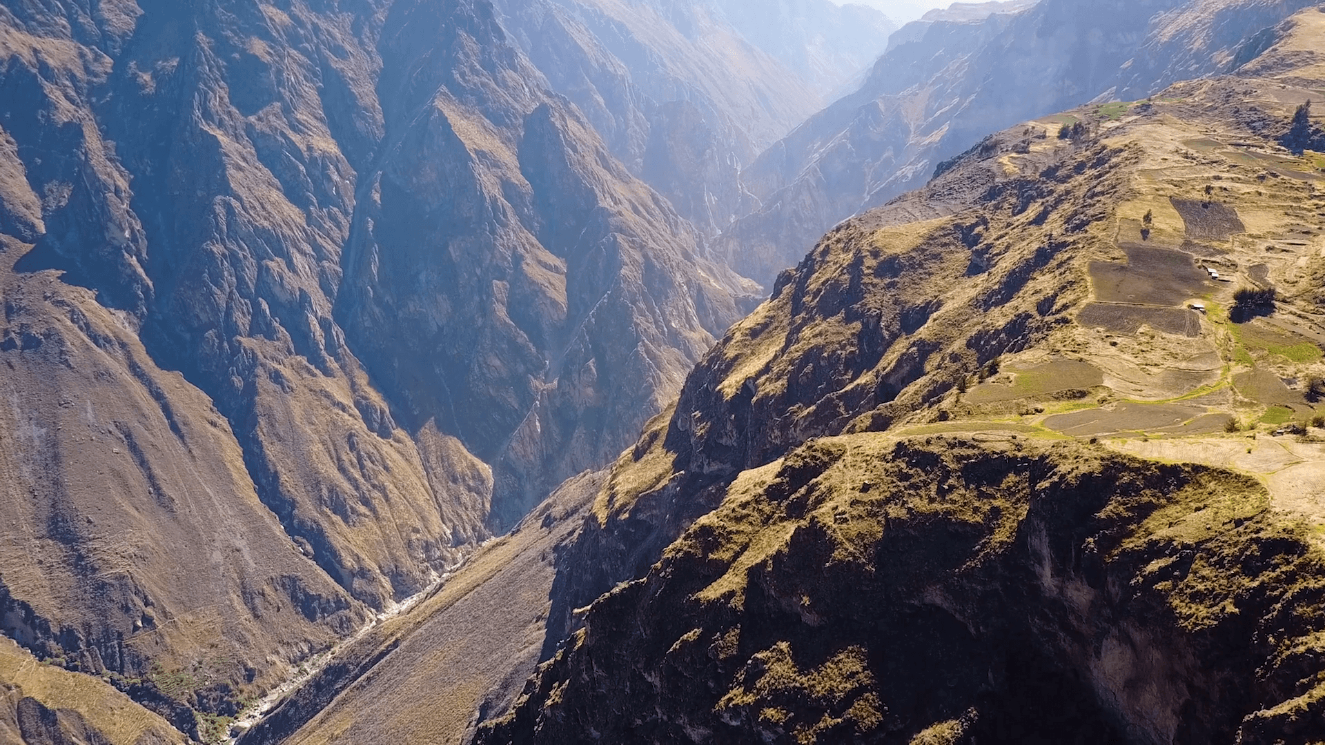 Drone aerial flying sideways over the massive Colca Canyon valley