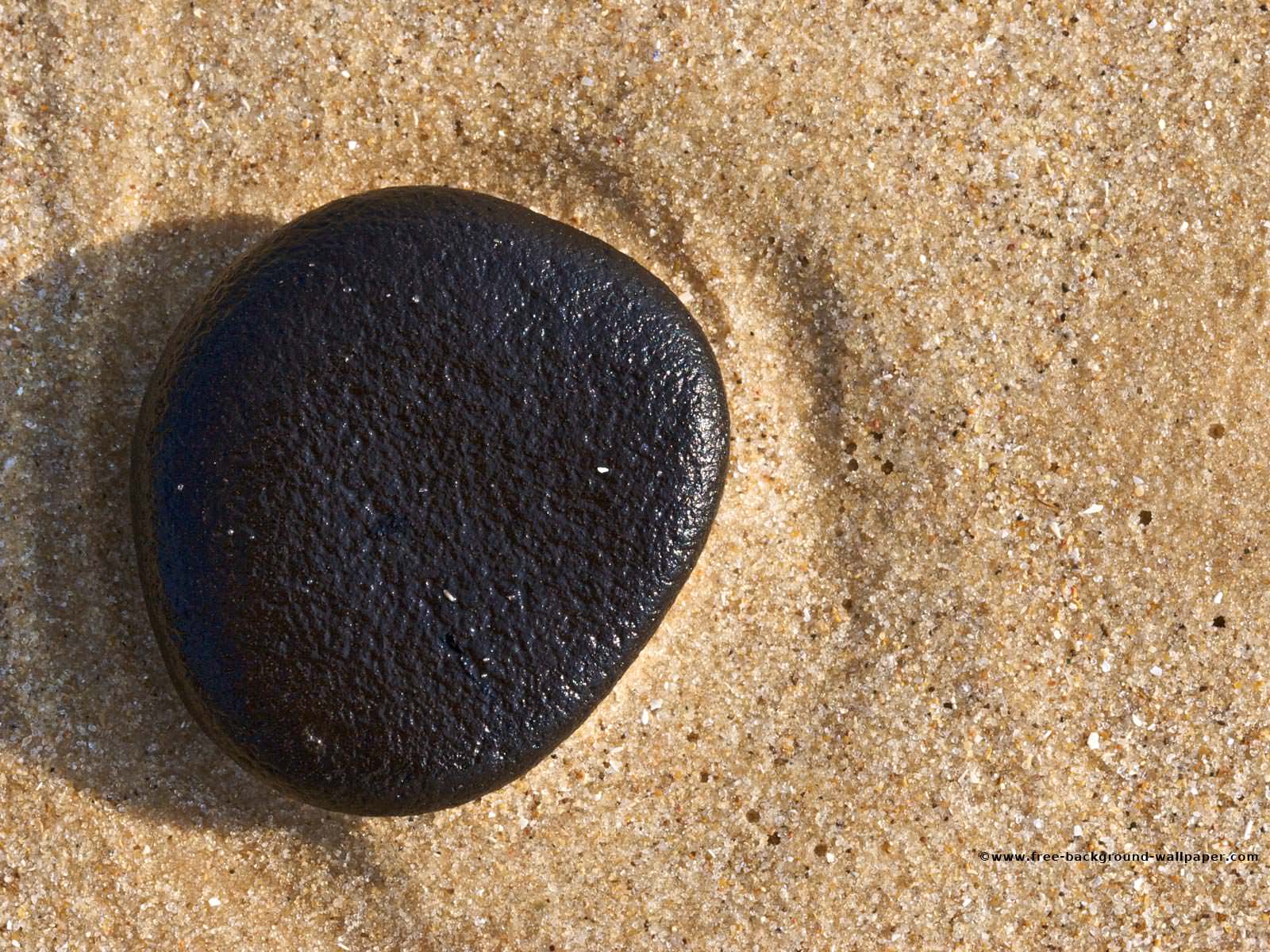 Black Pebble on a Beach Beach Background Wallpaper