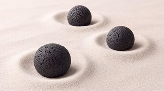 Minimalist Black Lava Stones in Fine Sand