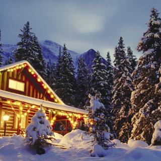 Snow covered cabin wallpaper