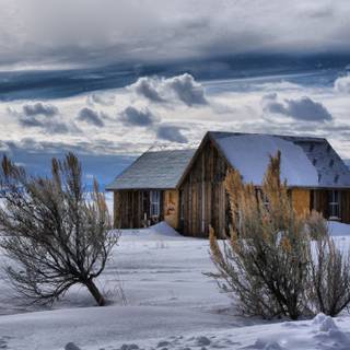 Snow covered cabin wallpaper