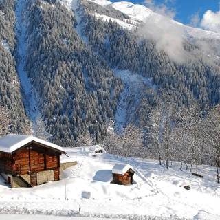 Snow covered cabin wallpaper