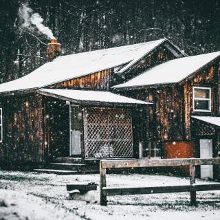 Snow covered cabin wallpaper