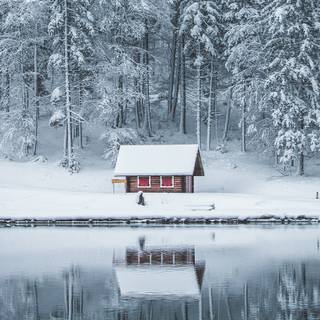 Snow covered cabin wallpaper