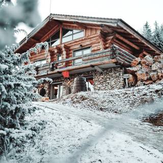 Snow covered cabin wallpaper