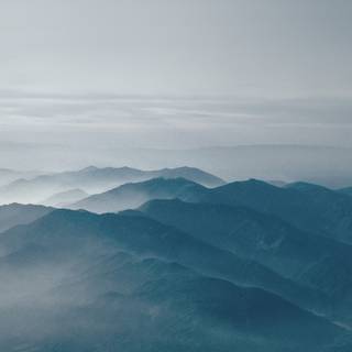 Foggy spring mountains wallpaper