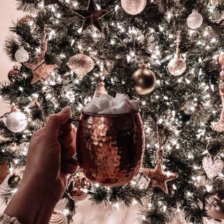 Hot chocolate with a Christmas tree wallpaper