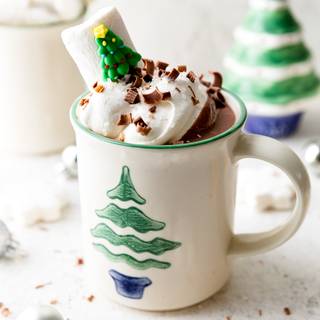 Hot chocolate with a Christmas tree wallpaper
