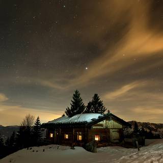 Winter cabin at night wallpaper