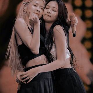 Jennie and Rose hug wallpaper