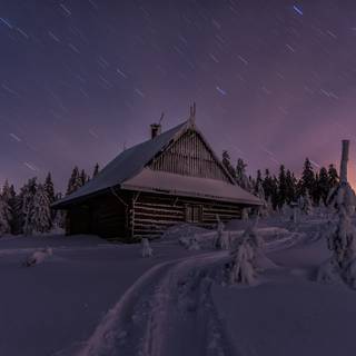 Winter cabin at night wallpaper