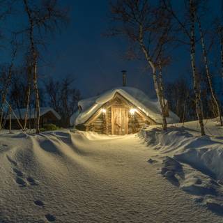 Winter cabin at night wallpaper