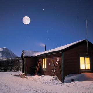 Winter cabin at night wallpaper