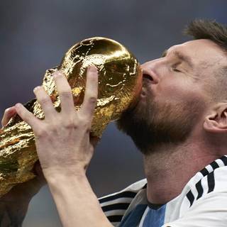 Lionel Messi Kissing the World Cup trophy wallpaper