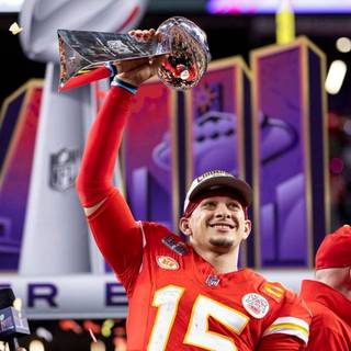 Mahomes holding Super Bowl LVIII trophy wallpaper