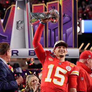 Mahomes holding Super Bowl LVIII trophy wallpaper
