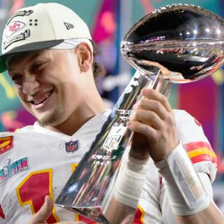 Mahomes holding Super Bowl LVIII trophy wallpaper