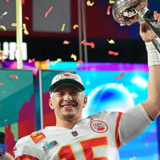 Mahomes holding Super Bowl LVIII trophy wallpaper