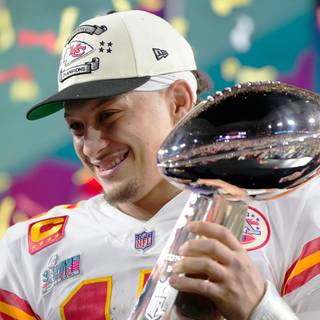 Mahomes holding Super Bowl LVIII trophy wallpaper