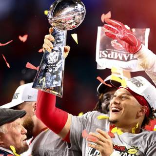 Mahomes holding Super Bowl LVIII trophy wallpaper