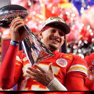 Mahomes holding Super Bowl LVIII trophy wallpaper