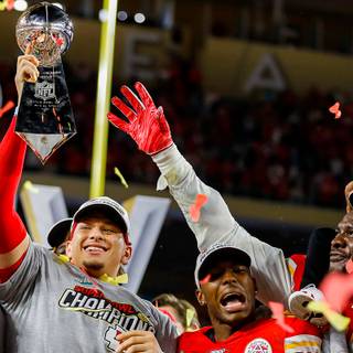 Mahomes holding Super Bowl LVIII trophy wallpaper