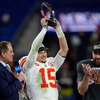 Mahomes holding Super Bowl LVIII trophy wallpaper