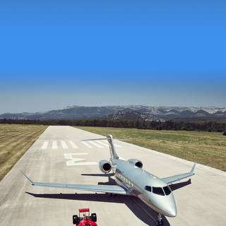 Private jet and Ferrari wallpaper