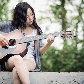 Girl playing guitar wallpaper